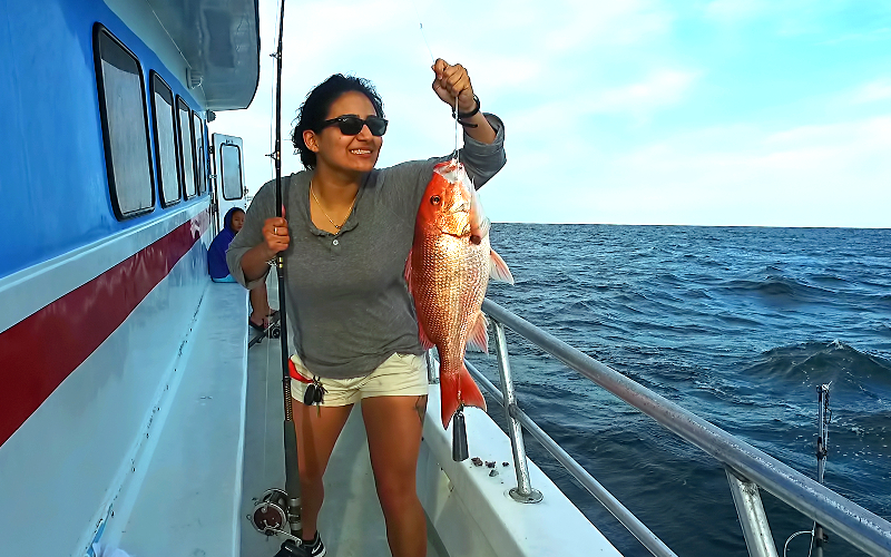 woman holding red snapper fish destin party boat